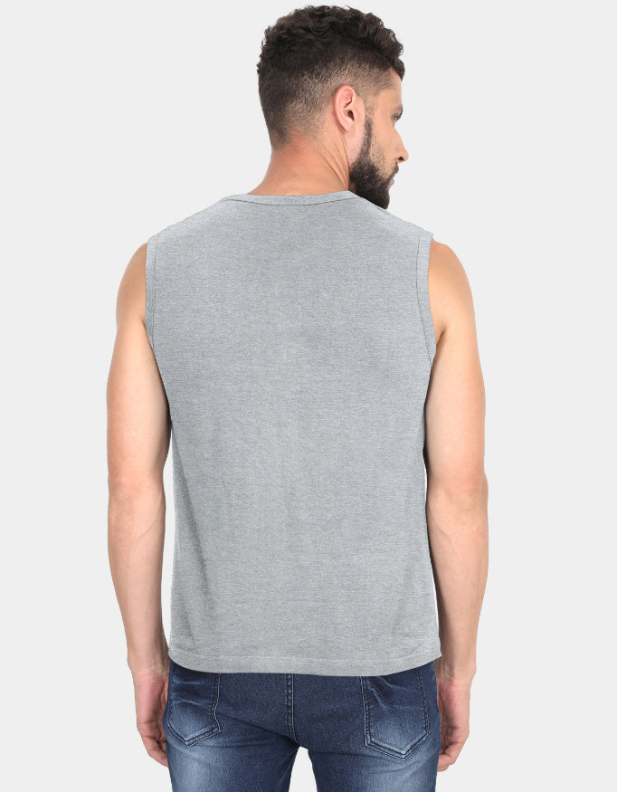 Man wearing a gray sleeveless shirt and blue jeans on a light gray background
Clyne Tee