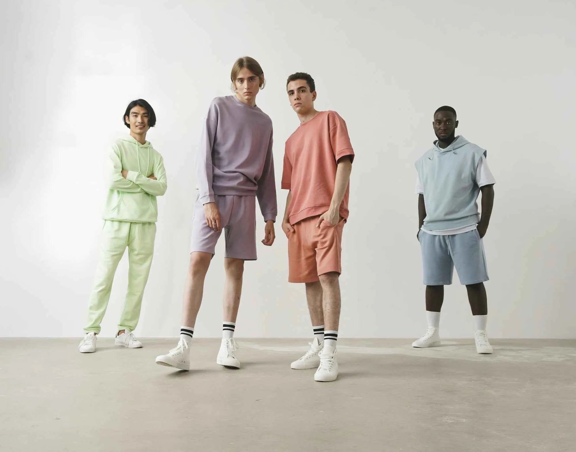 Four CozyVora models wearing pastel-colored outfits standing against a plain background