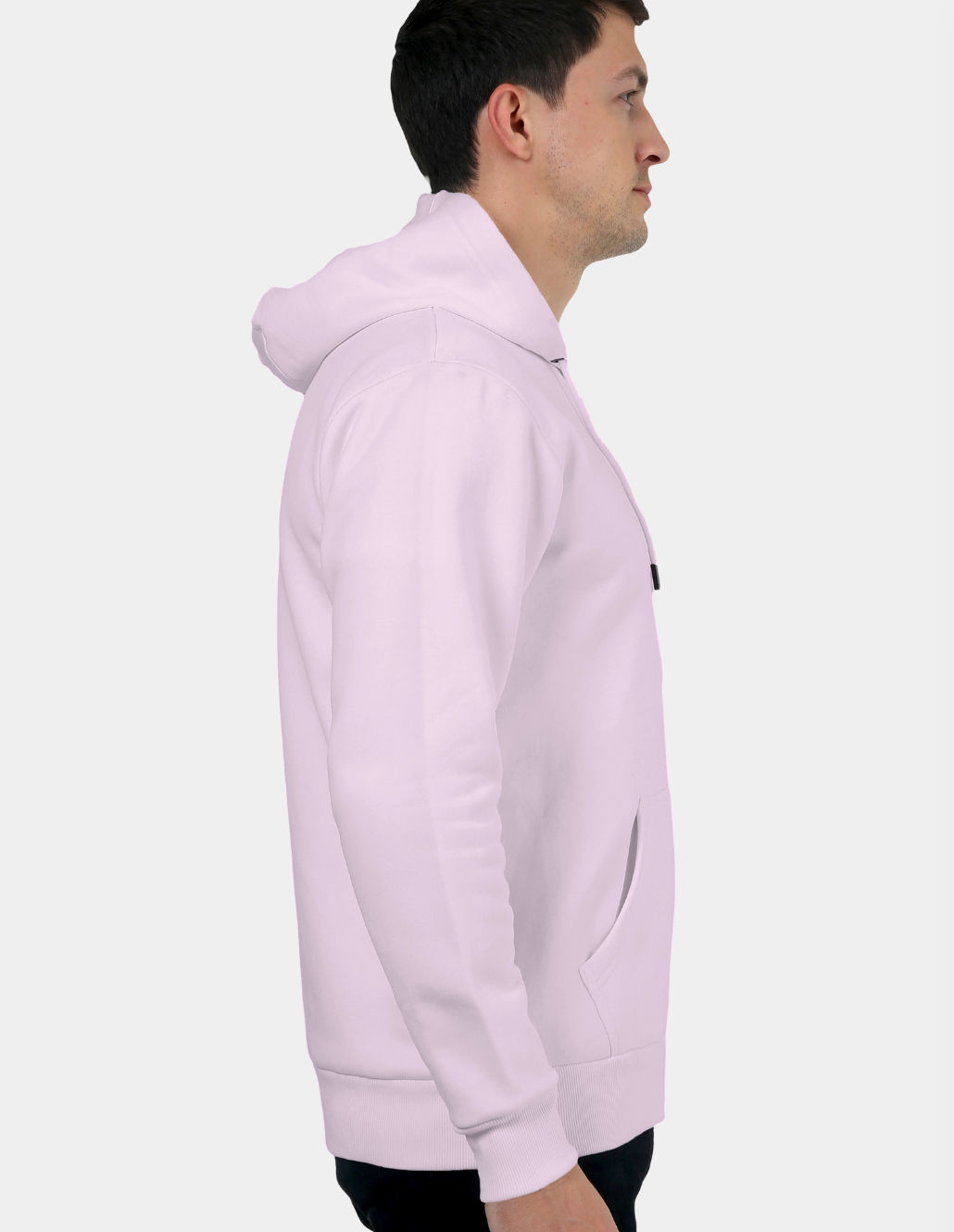 Person wearing a light pink hoodie on a white background