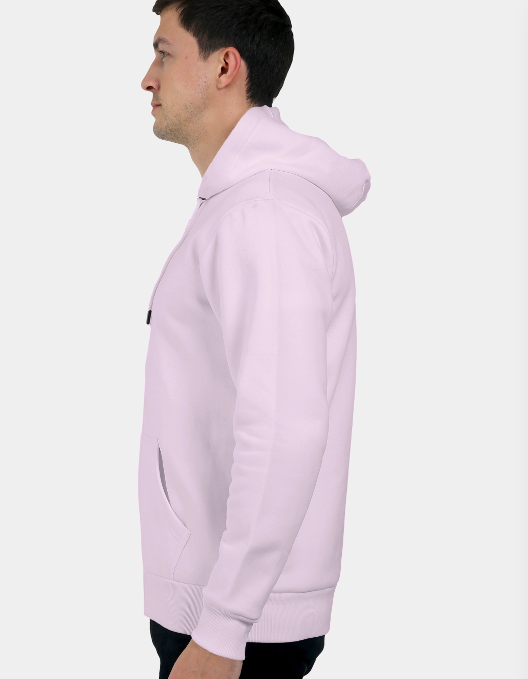 Person wearing a light pink hoodie on a white background