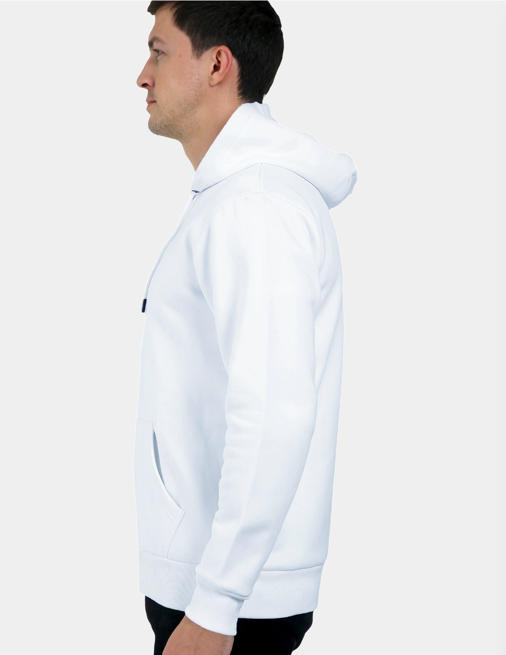 Person wearing a white hoodie on a plain background