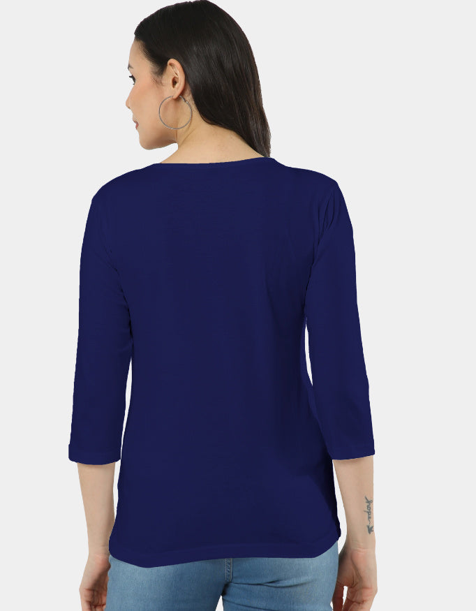 Woman wearing a blue top with three-quarter sleeves on a white background
The Linea Tee